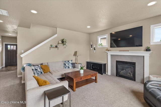 3402 N Croghan Dr, Post Falls, ID 83854 - carpeted living room featuring healthy amount of natural light, a textured ceiling, recessed lighting, a fireplace, and baseboards