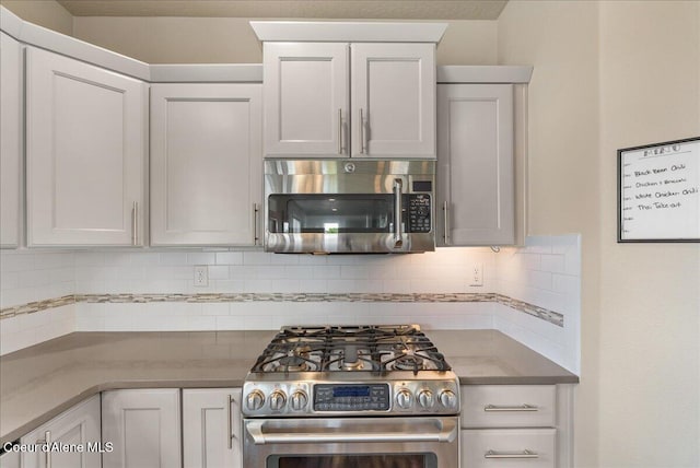 3402 N Croghan Dr, Post Falls, ID 83854 - kitchen featuring stainless steel appliances, backsplash, and white cabinetry