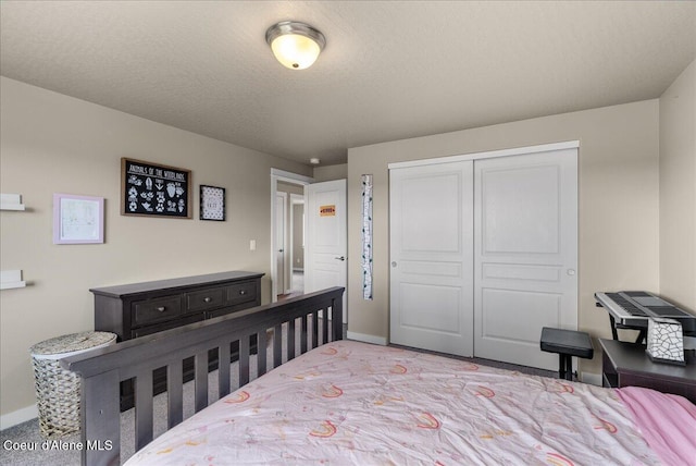 3402 N Croghan Dr, Post Falls, ID 83854 - carpeted bedroom with baseboards, a closet, and a textured ceiling