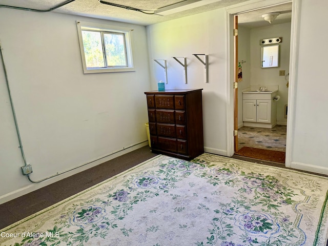 3216 Dufort Rd, Sagle, ID 83860 - bedroom with ensuite bath, baseboards, a sink, and carpet
