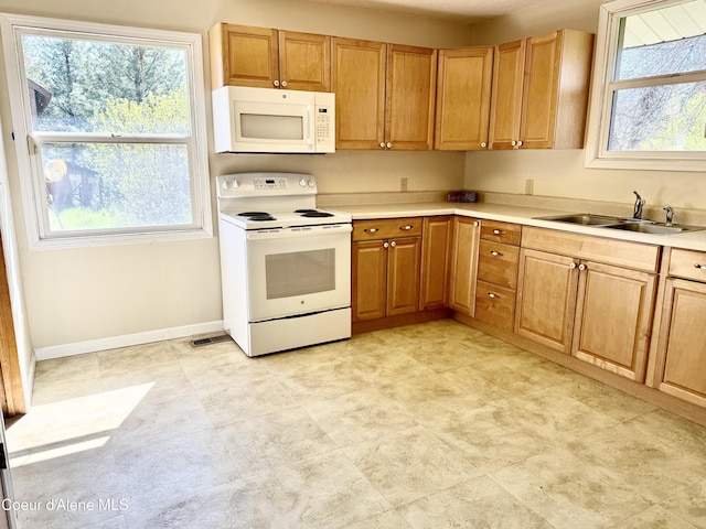 3216 Dufort Rd, Sagle, ID 83860 - kitchen featuring white appliances, a sink, light countertops, and baseboards