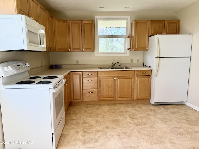 3216 Dufort Rd, Sagle, ID 83860 - kitchen featuring white appliances, a sink, and light countertops