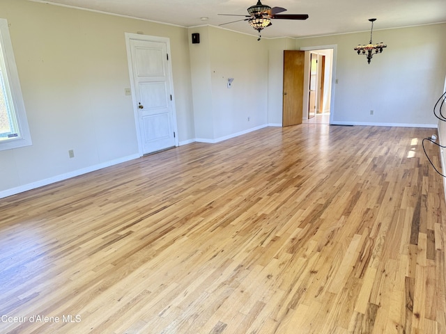 3216 Dufort Rd, Sagle, ID 83860 - spare room with light wood finished floors, a ceiling fan, crown molding, a chandelier, and baseboards