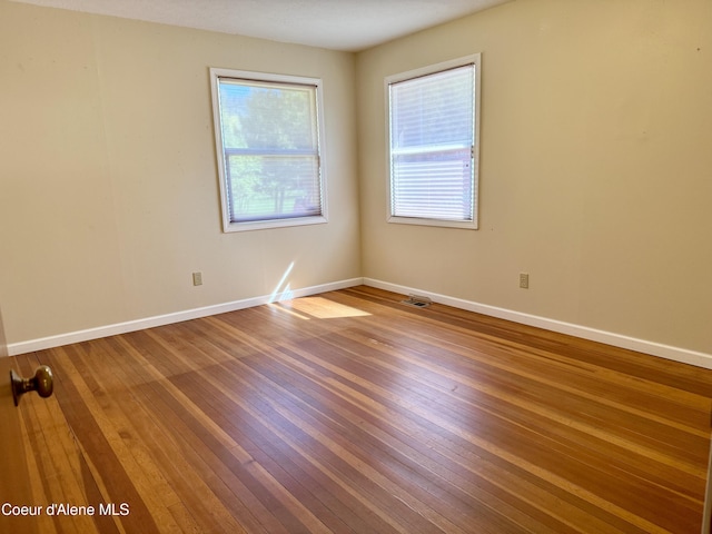 3216 Dufort Rd, Sagle, ID 83860 - spare room with plenty of natural light, hardwood / wood-style flooring, and baseboards
