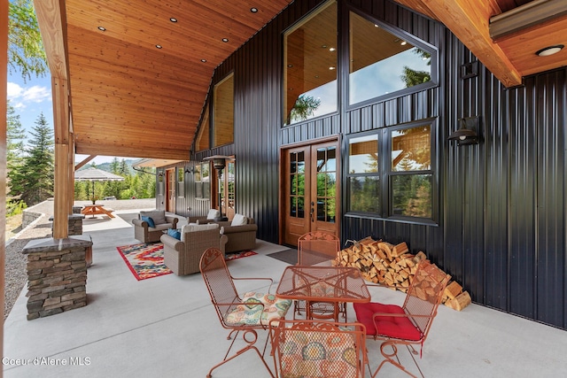 view of patio with french doors, an outdoor hangout area, and outdoor dining space