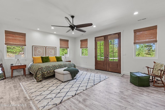 bedroom with access to exterior, multiple windows, wood finished floors, recessed lighting, and baseboards