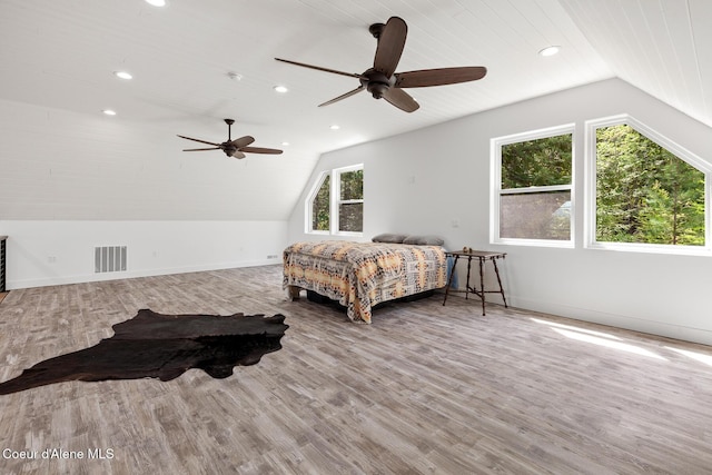 bedroom featuring lofted ceiling, wood finished floors, recessed lighting, baseboards, and ceiling fan