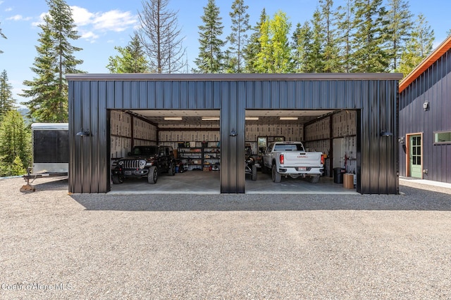 view of car parking with a detached garage