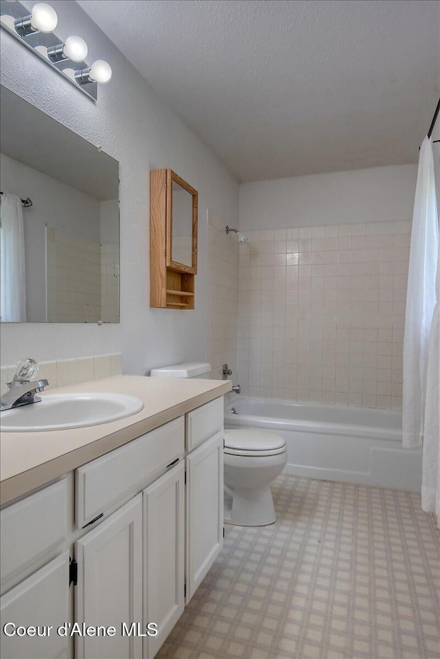 full bathroom featuring shower / tub combo, tile patterned floors, toilet, and vanity