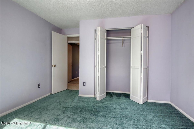 unfurnished bedroom with carpet, a closet, and a textured ceiling