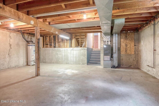unfinished basement featuring water heater, stairway, and heating unit
