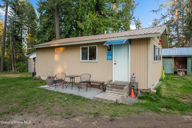 8072 W Radmer Rd, Rathdrum, ID 83858 - back of property featuring entry steps, metal roof, a yard, and an outdoor structure