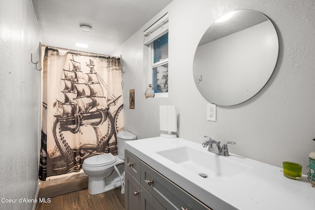 8072 W Radmer Rd, Rathdrum, ID 83858 - full bathroom featuring wood finished floors, toilet, vanity, and curtained shower