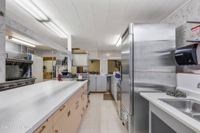8072 W Radmer Rd, Rathdrum, ID 83858 - kitchen with light countertops, a sink, light flooring, freestanding refrigerator, and wallpapered walls