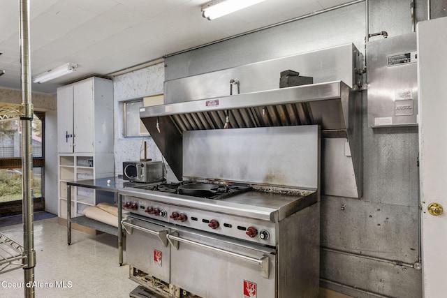 8072 W Radmer Rd, Rathdrum, ID 83858 - kitchen featuring tile patterned floors, stainless steel microwave, and white cabinets