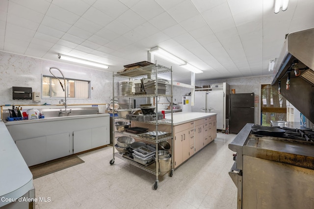 8072 W Radmer Rd, Rathdrum, ID 83858 - kitchen with freestanding refrigerator, light floors, and light countertops