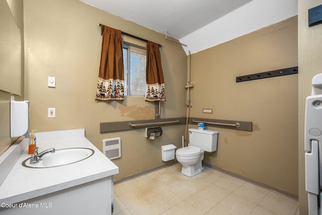 8072 W Radmer Rd, Rathdrum, ID 83858 - bathroom with baseboards, vaulted ceiling, toilet, vanity, and heating unit