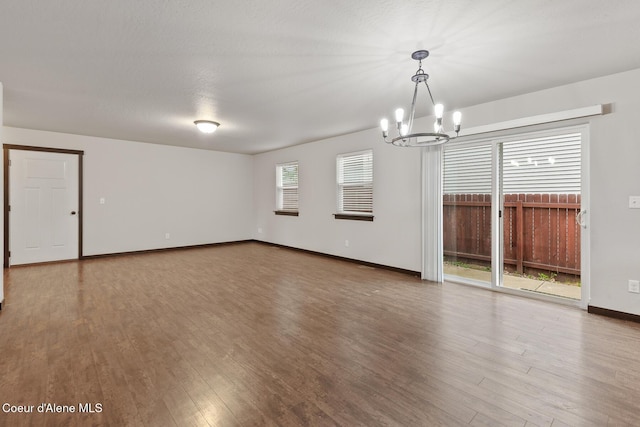 1201 E Locust Ave, Coeur Dalene, ID 83814 - unfurnished room with a chandelier, wood finished floors, and baseboards