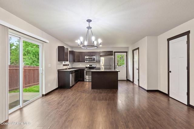 1201 E Locust Ave, Coeur Dalene, ID 83814 - kitchen featuring stainless steel appliances, a chandelier, a sink, and dark wood-style flooring