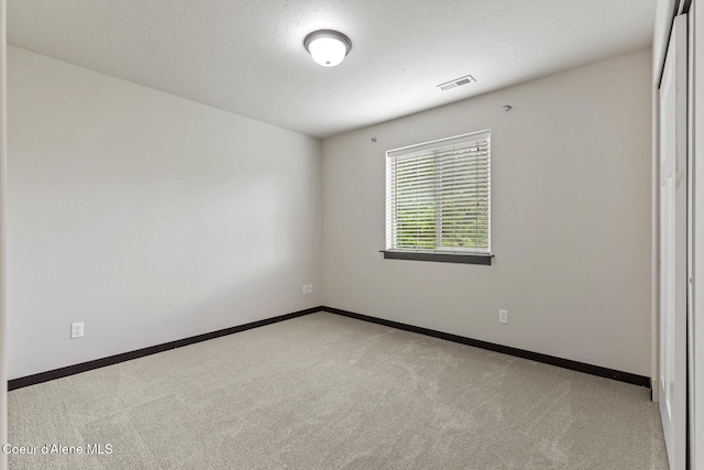1201 E Locust Ave, Coeur Dalene, ID 83814 - spare room featuring light colored carpet and baseboards