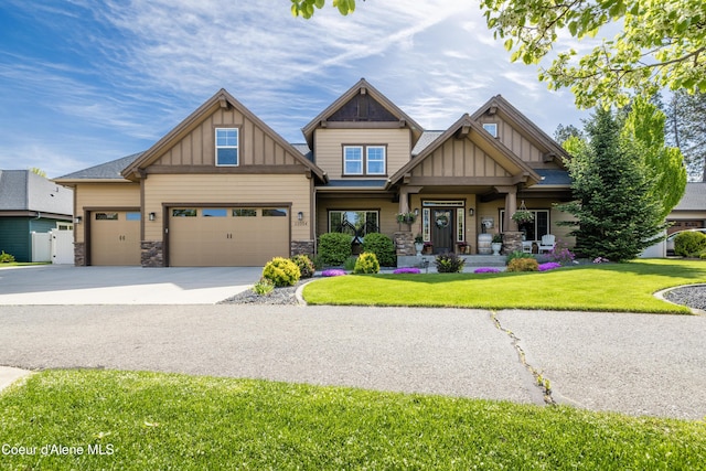 craftsman house featuring board and batten siding, covered porch, a front yard, and stone siding
