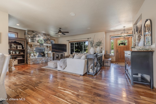 living area with hardwood / wood-style floors, ceiling fan, plenty of natural light, recessed lighting, and a chandelier