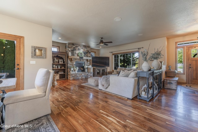 living room with a ceiling fan, hardwood / wood-style flooring, a fireplace, recessed lighting, and baseboards
