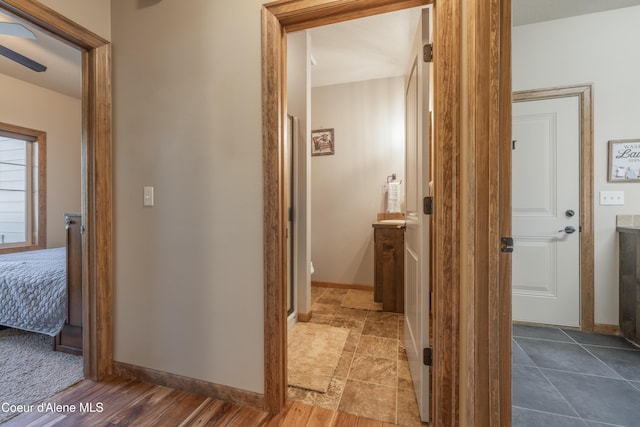 hall featuring baseboards