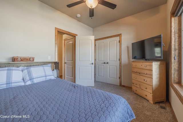 bedroom featuring carpet, vaulted ceiling, ceiling fan, and a closet