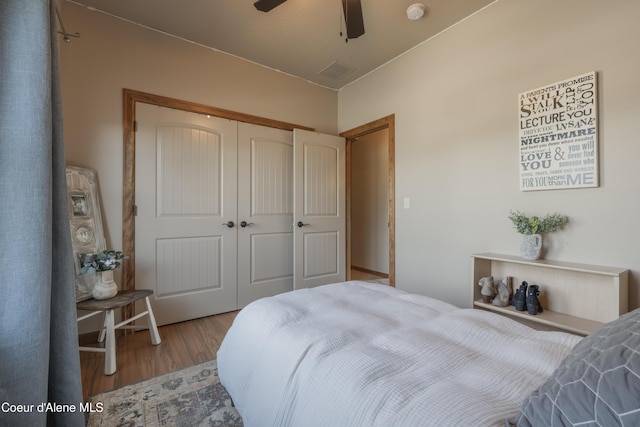 bedroom with wood finished floors, a closet, and a ceiling fan