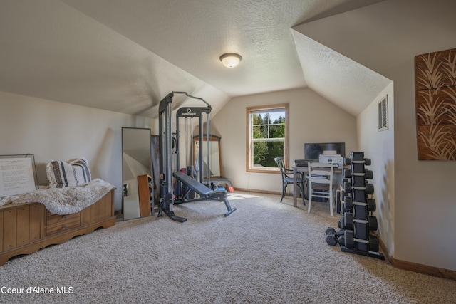 exercise room featuring carpet, lofted ceiling, a textured ceiling, and baseboards