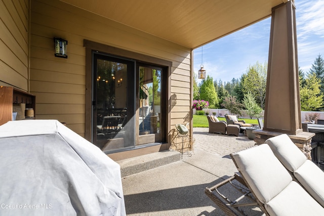 entrance to property with a patio area and an outdoor living space