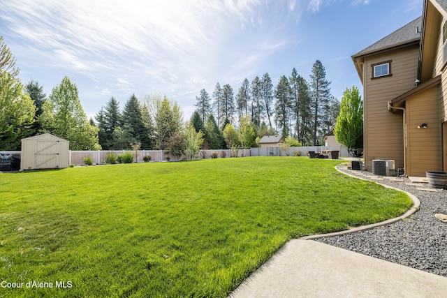 view of yard with a storage shed, central air condition unit, and an outdoor structure