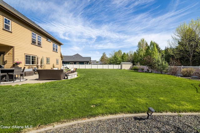 view of yard featuring an outdoor hangout area, a patio, a shed, and an outbuilding