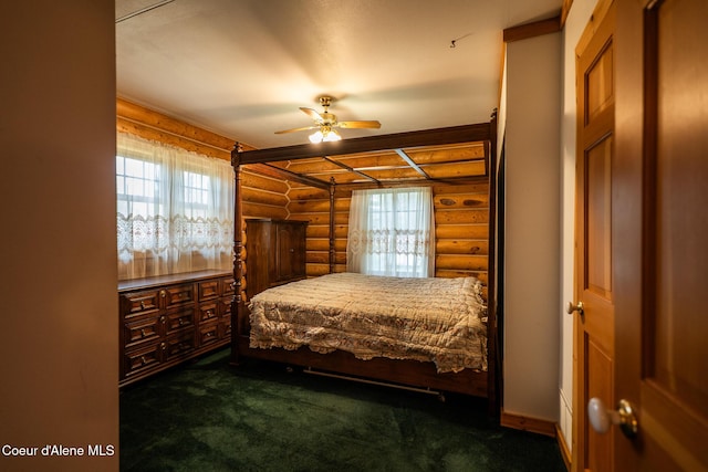 carpeted bedroom with log walls and multiple windows