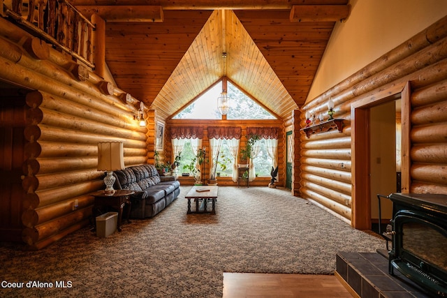 living area with a wood stove, carpet floors, wood ceiling, and a high ceiling