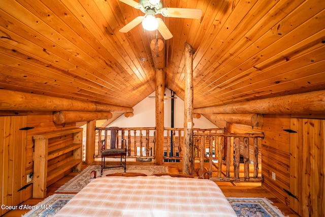 living area with wood ceiling, a ceiling fan, hardwood / wood-style flooring, and rustic walls
