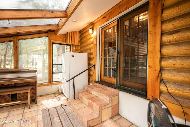 unfurnished sunroom featuring a skylight