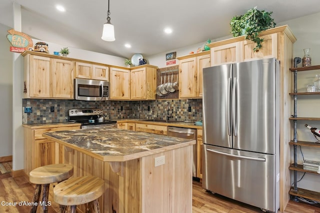 304 Hagman Rd, Nordman, ID 83848 - kitchen featuring stainless steel appliances, light brown cabinetry, light wood-style flooring, a sink, and backsplash