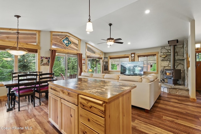 304 Hagman Rd, Nordman, ID 83848 - kitchen with ceiling fan, wood finished floors, lofted ceiling, a wood stove, and pendant lighting