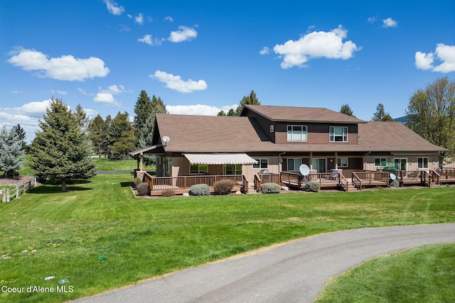 108 Ironwood Dr, Blanchard, ID 83804 - view of front facade featuring a wooden deck, a front yard, and roof with shingles