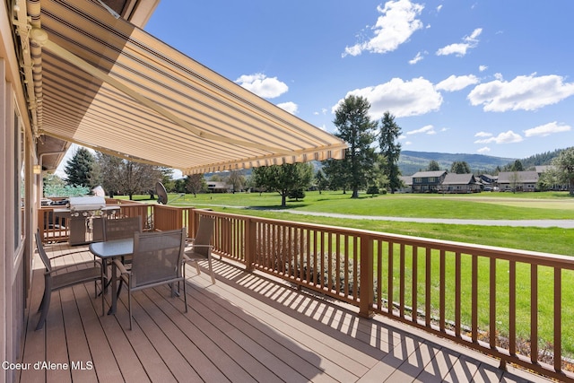 108 Ironwood Dr, Blanchard, ID 83804 - wooden deck featuring outdoor dining space, a yard, and a mountain view