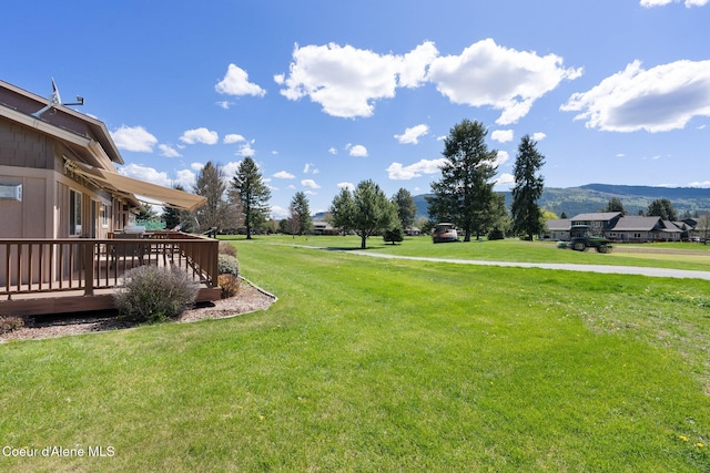 108 Ironwood Dr, Blanchard, ID 83804 - view of grassy yard with a deck with mountain view