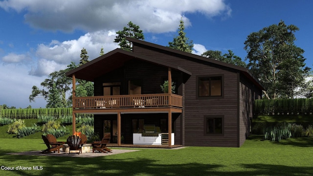 rear view of house with a yard, a balcony, an outdoor fire pit, and a patio