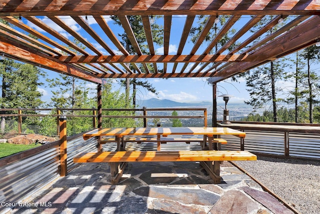 12251 W Blessing Hill Rd, Post Falls, ID 83854 - view of patio with outdoor dining area, a mountain view, and a pergola