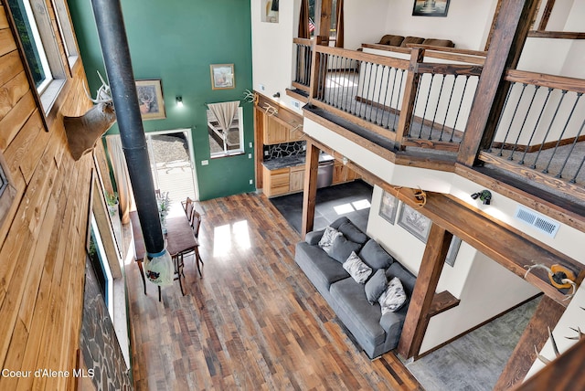 12251 W Blessing Hill Rd, Post Falls, ID 83854 - living room featuring a towering ceiling, wood finished floors, and a wood stove
