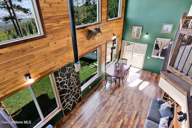 12251 W Blessing Hill Rd, Post Falls, ID 83854 - living room featuring healthy amount of natural light, wood finished floors, wooden walls, and a towering ceiling