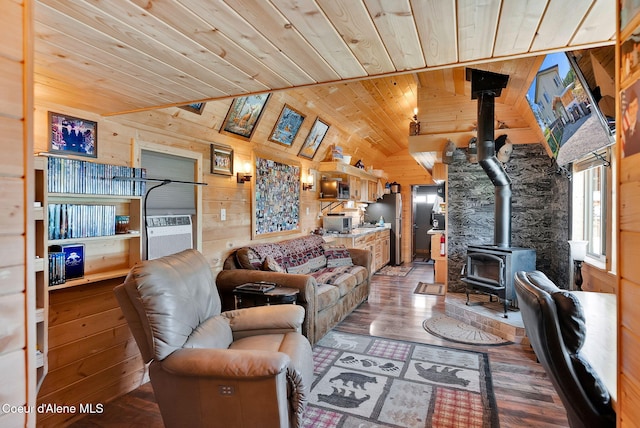 12251 W Blessing Hill Rd, Post Falls, ID 83854 - living area with a wood stove, wooden walls, wooden ceiling, vaulted ceiling, and wood finished floors