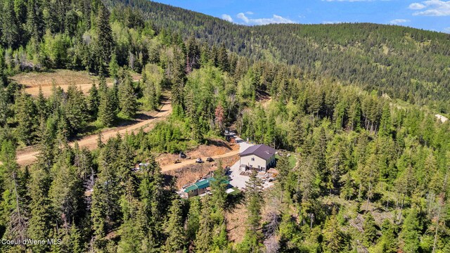 12251 W Blessing Hill Rd, Post Falls, ID 83854 - view from above of property featuring a heavily wooded area and a mountainous background