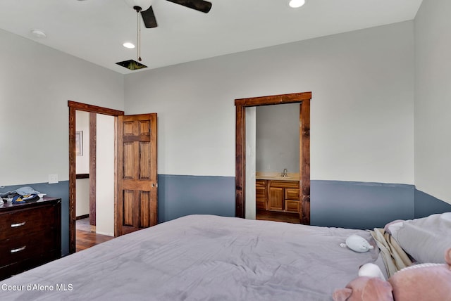 12251 W Blessing Hill Rd, Post Falls, ID 83854 - bedroom with wood finished floors, recessed lighting, a sink, and a ceiling fan
